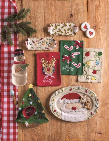 Snowman Tidbit Dish with Tree Spreader, A divided stoneware serving dish shaped like a snowman with a red HO HO HO scarf and black top hat, paired with a wooden spreader topped with a painted Christmas tree.