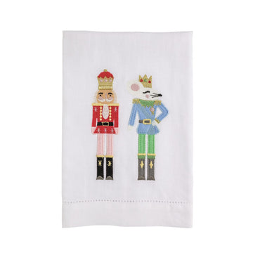 Nutcracker Velvet Bow Embroidered Hand Towel, White hemstitched hand towel embroidered with two figures, a nutcracker soldier in a red jacket and a crowned mouse king in a blue jacket, standing side by side.