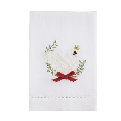 Crowned Swan Embroidered Hand Towel, A folded white hand towel embroidered with a white swan wearing a gold crown, framed by green sprigs, with a red velvet bow and a hemstitched bottom border.