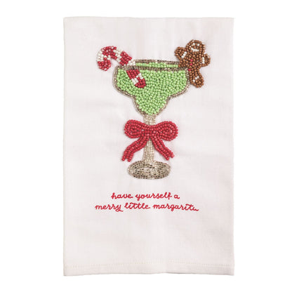 Merry Little Margarita Beaded Hand Towel, White cotton hand towel with a beaded margarita glass in pale green and silver, a red beaded bow on the stem, a candy cane and a gingerbread man, and red embroidered script reading have yourself a merry little margarita.