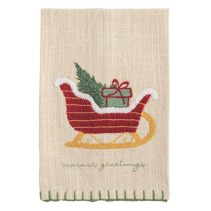 Season's Greetings Sleigh Embroidered Hand Towel, A natural cream cotton hand towel embroidered with a red sleigh on gold runners carrying a green tree and a wrapped gift, with season's greetings stitched in green below and a green stitched hem.