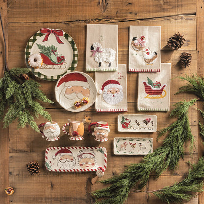 Season's Greetings Sleigh Embroidered Hand Towel, A natural cream cotton hand towel embroidered with a red sleigh on gold runners carrying a green tree and a wrapped gift, with season's greetings stitched in green below and a green stitched hem.