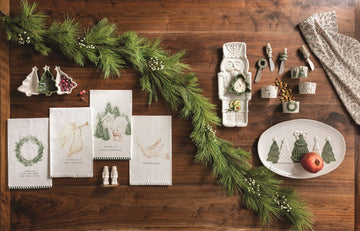 Dreaming of a White Christmas Angel Hand Towel, A cream cotton hand towel printed with a gold watercolor angel blowing a trumpet above the words Dreaming of a White Christmas, with a sage and cream striped hem.