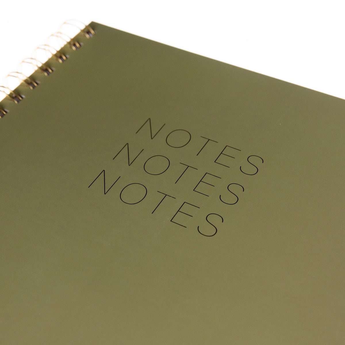 Green Spiral Desk Journal, An olive green spiral bound journal with Notes Notes Notes stamped in gold foil on the cover.