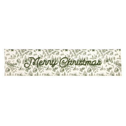 Green Toile Merry Christmas Table Runner, A long cream cotton table runner printed in green Christmas toile with Merry Christmas embroidered in green script across the center.