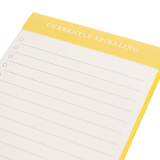 Spiraling Scallop List Pad, A cream list pad with a yellow header reading Currently Spiraling and a scalloped bottom edge.