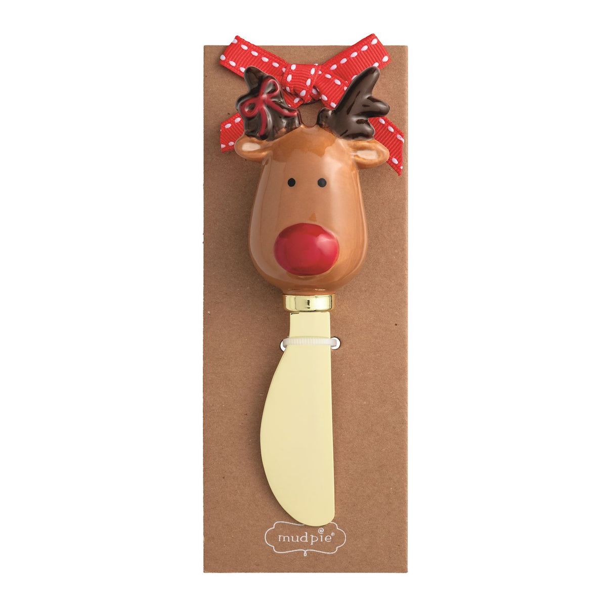 Reindeer Handle Cheese Spreader, 5.5 Inch, A brass-toned spreader with a hand-painted reindeer head handle, dark antlers and a red nose, mounted on a kraft card with a red ribbon bow.