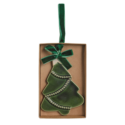 Green Glazed Stoneware Christmas Tree Ornament, A green glazed ceramic Christmas tree ornament with rows of raised dots and a green velvet ribbon bow, lying in an open kraft gift box.