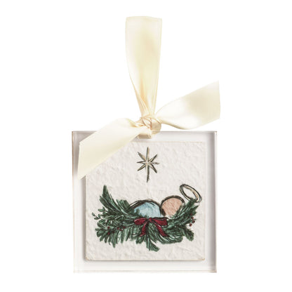 Nativity Scene Acrylic Ornament, Square clear acrylic ornament printed with the Christ child asleep in a bed of pine and holly tied with a red bow, a star above, hung from a cream grosgrain ribbon bow.