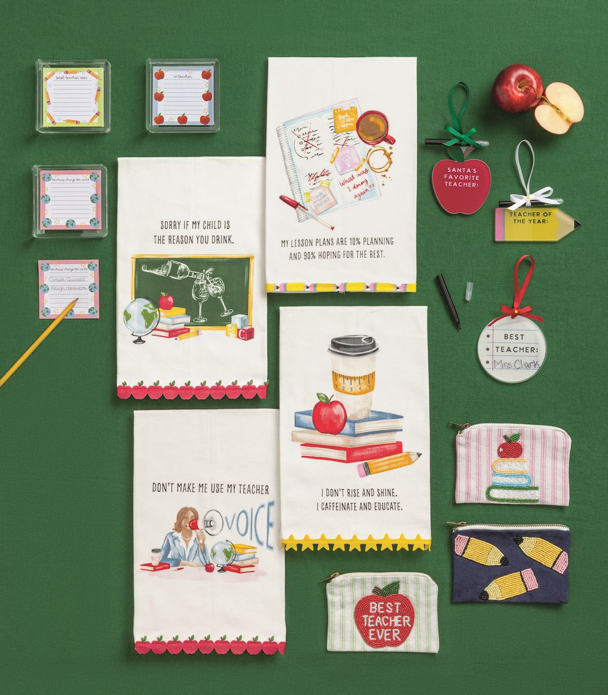 Santa's Favorite Teacher Apple Ornament with Marker, A red apple shaped acrylic ornament reading Santa's Favorite Teacher with a green ribbon hanger, mounted on a kraft card with a black marker tucked behind the bow.