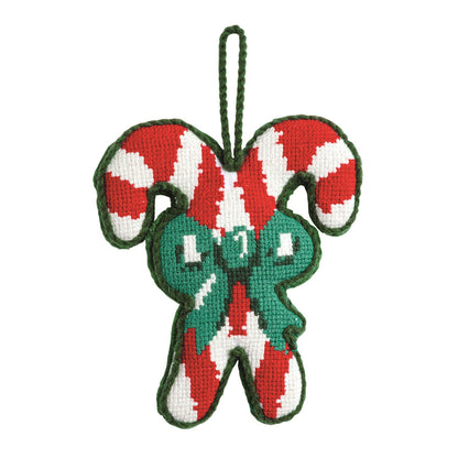 Candy Cane Needlepoint Christmas Ornament, A needlepoint ornament of two crossed red and white candy canes tied with a green stitched bow, edged in green with a green cord hanging loop.