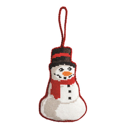 Snowman Needlepoint Ornament, A needlepoint ornament shaped like a snowman in a black top hat with a red band, orange carrot nose, red scarf and black buttons, edged in red stitching with a red cord loop.