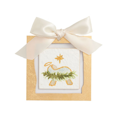 Baby Jesus Gold Acrylic Nativity Ornament, A square gold bordered acrylic ornament holding a painted scene of the infant Jesus in a manger of greenery under a gold star, tied with an ivory satin bow.