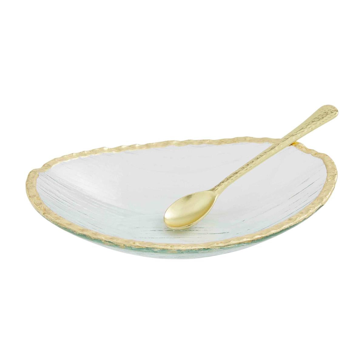 Gold Edge Glass Dip Bowl and Spoon Set, A shallow oval clear glass dish with a torn gold-painted rim, shown with a gold spoon with a hammered handle resting across it.