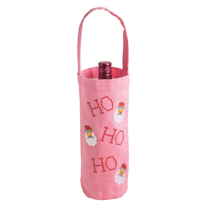 Ho Ho Ho Embroidered Canvas Wine Bag, A pink cotton canvas wine bag with a handle, embroidered ho ho ho three times with a stitched Santa face beside each line, a wine bottle sitting inside it.