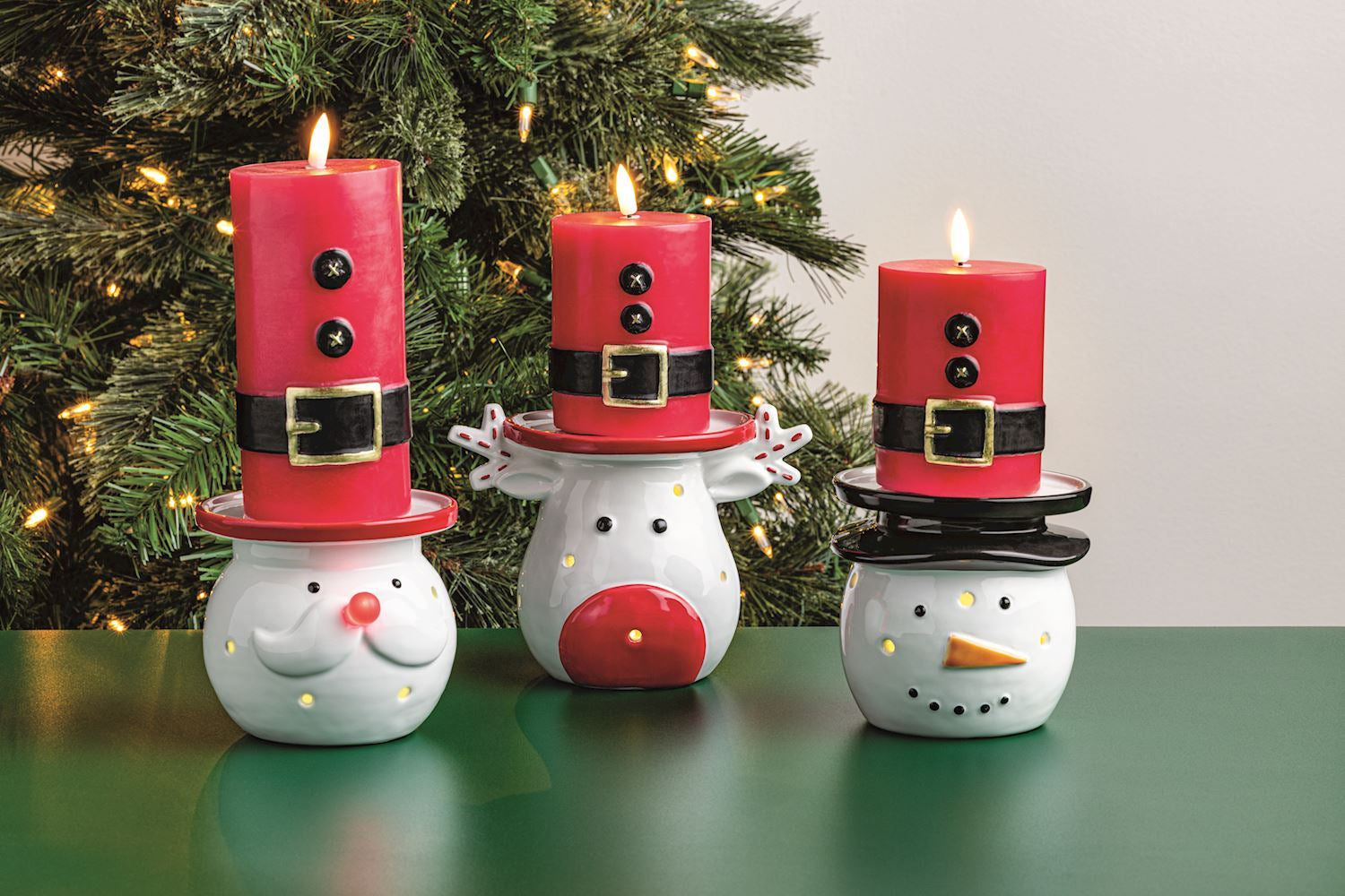 Santa Suit Flameless LED Pillar Candle, A red wax pillar candle painted as a Santa suit with two black buttons and a black belt with a gold buckle, wrapped in cellophane tied with twine.