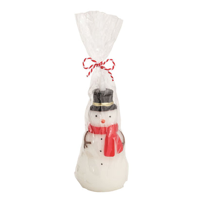 Snowman Figural Flameless Candle, A white snowman shaped wax candle with a black top hat, red scarf, carrot nose and coal buttons, wrapped in clear cellophane tied with red and white twine.