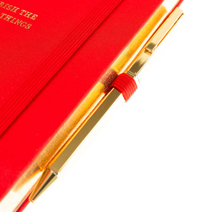 La Petite Presse Cherry Fabric-Bound Journal with Pen, A cherry red fabric journal with gold foil cherries and the words Cherish the Little Things on the cover, paired with a gold twist pen.