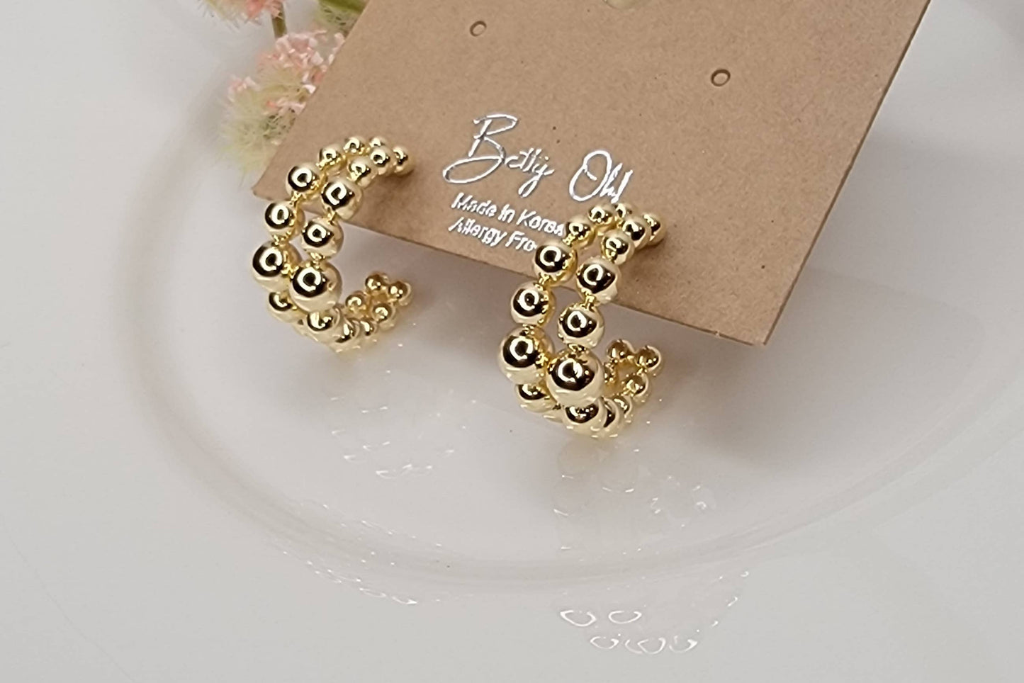 BEADED HOOP EARRINGS.