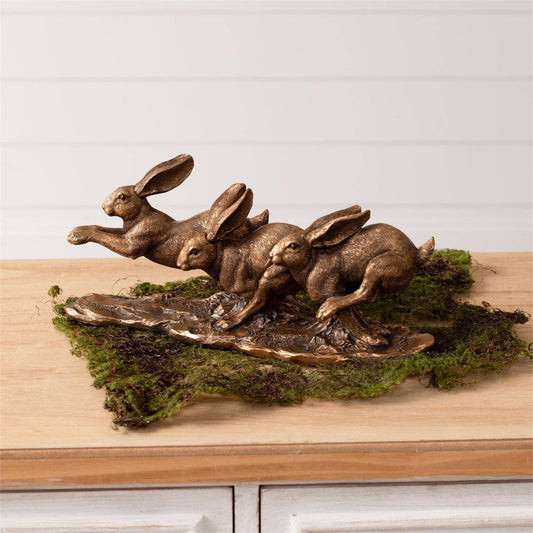 Figura de liebres doradas saltando