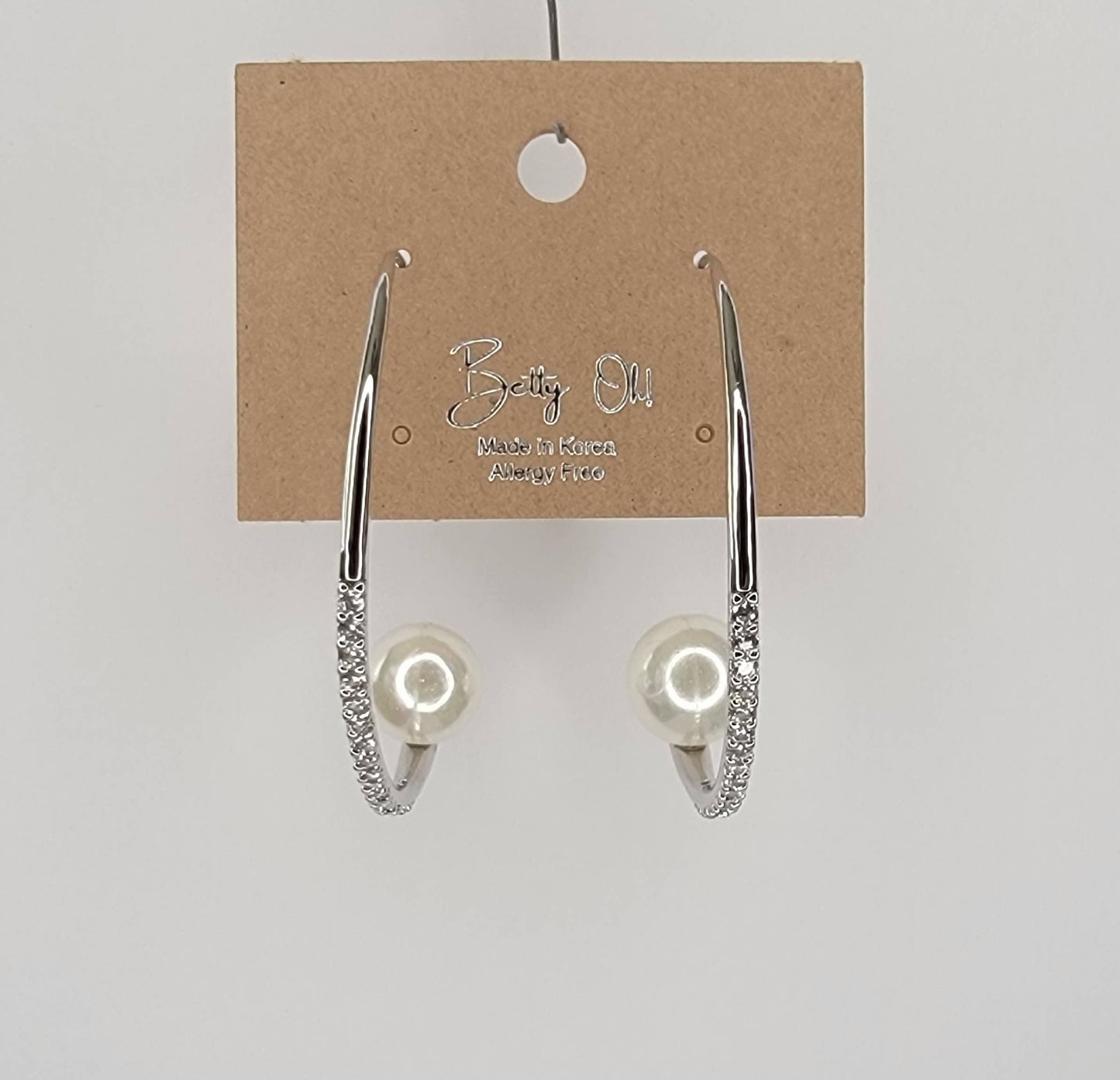 HOOP EARRING EMBEDDED WITH STONE LEADING TO A PEARL PERCHED