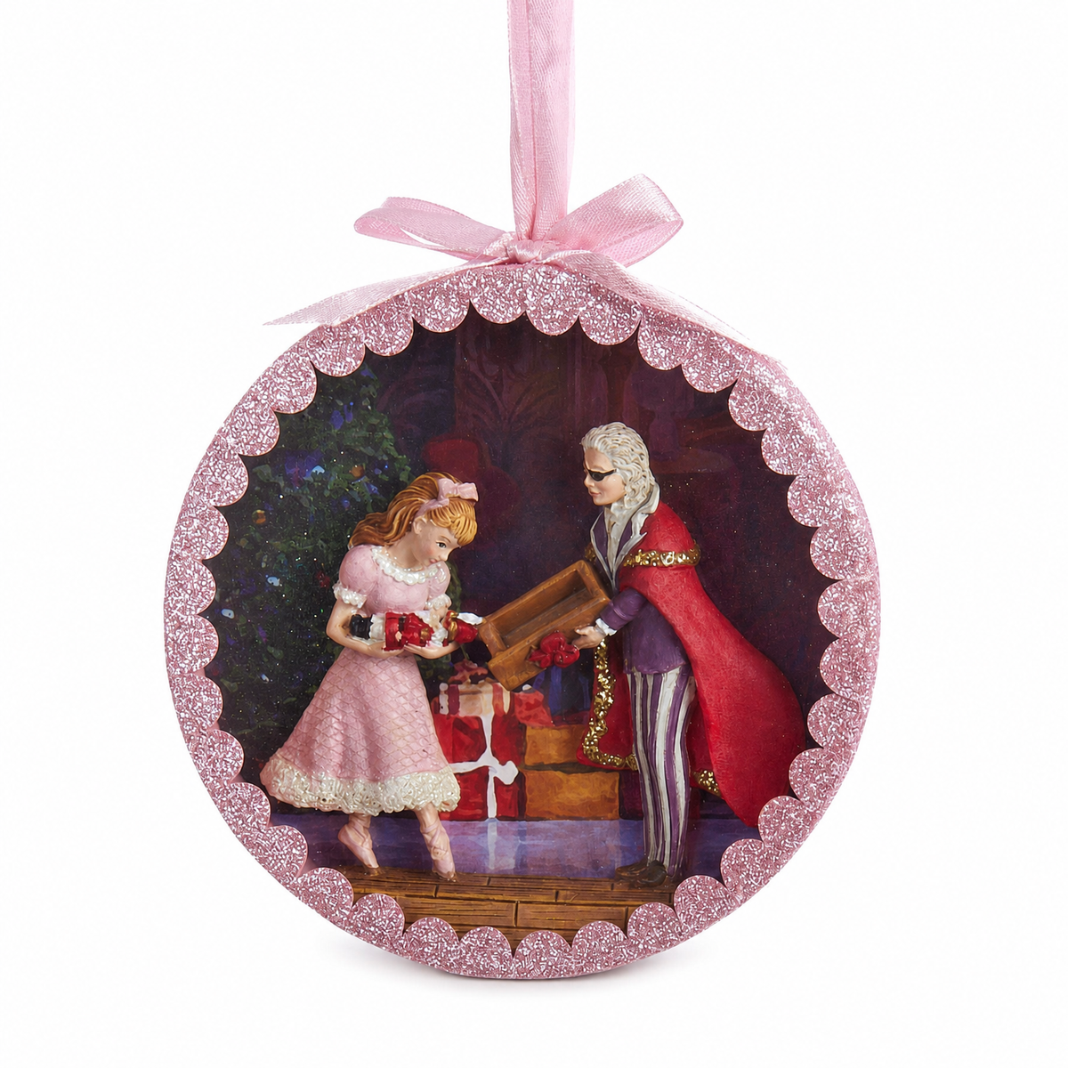 Nutcracker Suite Shadow Box Ornament, Drosselmeyer's Gift design: Drosselmeyer in his red cape handing Clara the nutcracker beside the tree
