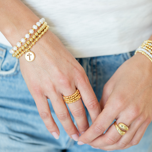 Iris espléndido - Pulsera elástica de cuentas con dije de cruz recortada
