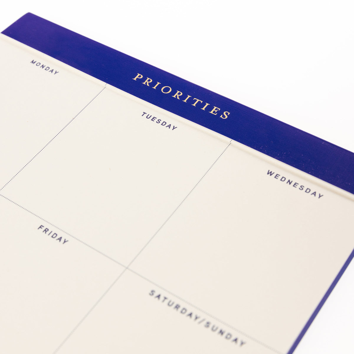 Cobalt Blue Legal Pad, A cream weekly planning pad with a cobalt blue header reading Priorities and a Monday through Sunday grid.