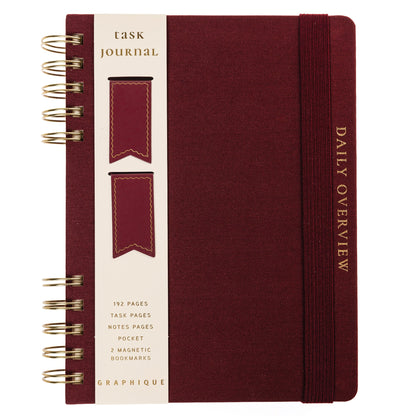 Burgundy Fabric-Bound Task Journal, A burgundy fabric-covered task journal with gold twin wire spirals and two maroon ribbon bookmark tabs, closed with an elastic band.