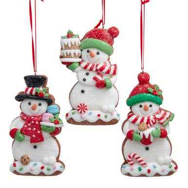A snowman shaped cookie ornament with a white iced body on a gingerbread base.