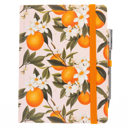 La Petite Presse L'Orange Fabric-Bound Journal with Pen, An orange grove fabric journal, closed with an orange elastic band and a silver pen tucked into a loop.
