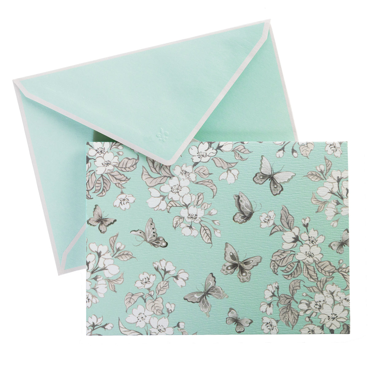 La Petite Presse Butterflies Boxed Correspondence Notes, A brown gift box open to reveal a seafoam green notecard with silver-foiled butterflies and cherry blossoms, paired with a matching mint envelope.