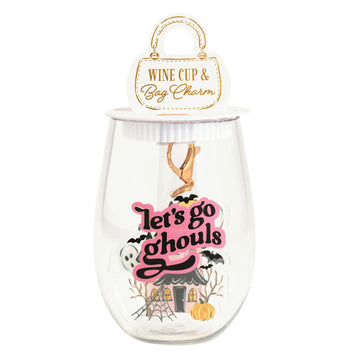 Lets Go Ghouls Wine Cup and Bag Charm Set, A clear stemless plastic wine cup printed with a haunted house, ghost, bats and pumpkin, with a pink and black lets go ghouls acrylic bag charm hanging inside it on a gold clip.