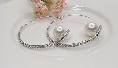 HOOP EARRING EMBEDDED WITH STONE LEADING TO A PEARL PERCHED