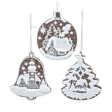 A gingerbread cookie ornament piped in raised white icing with a winter scene.