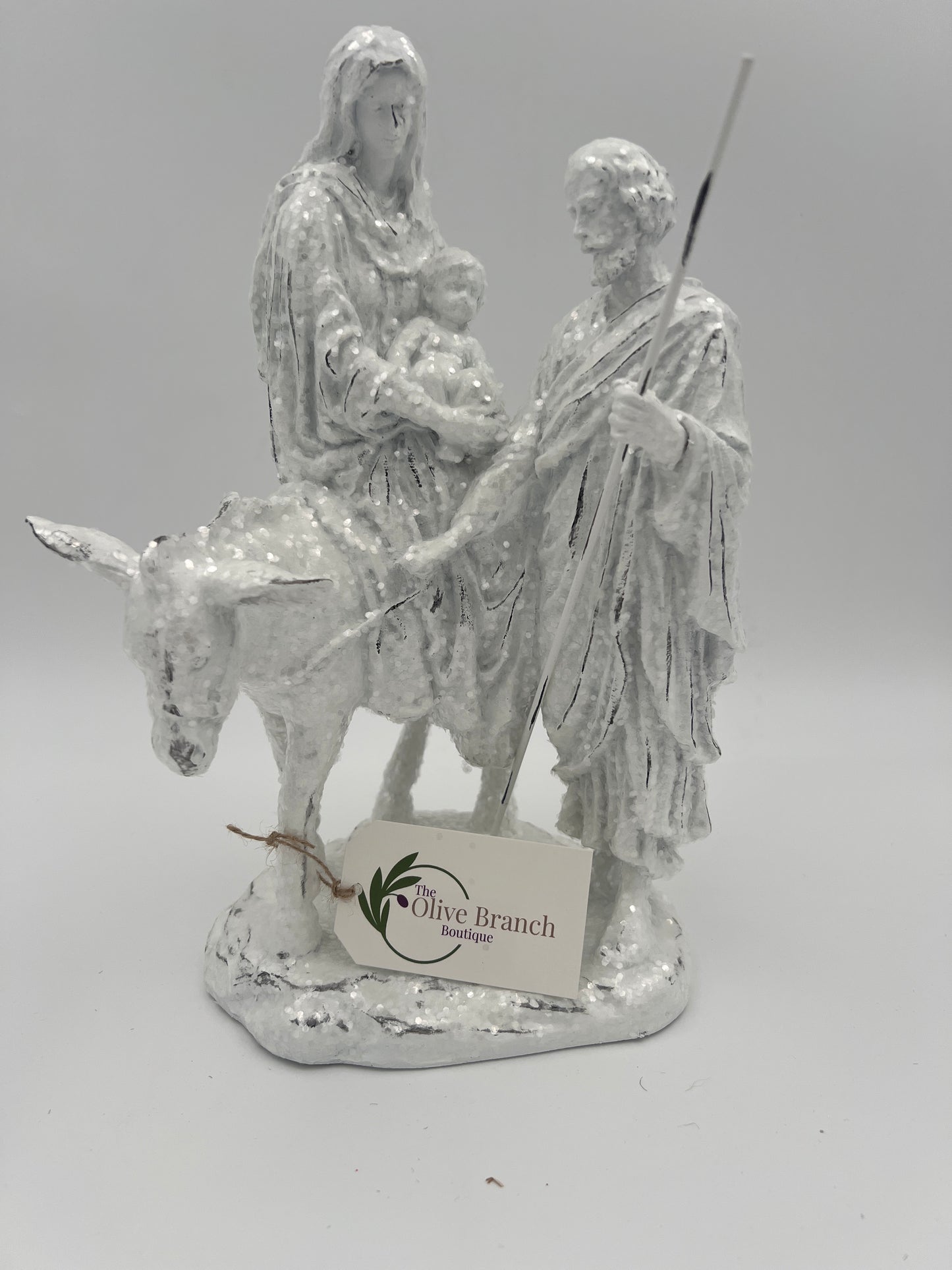 Natividad de José y María montados en burro con brillantina blanca