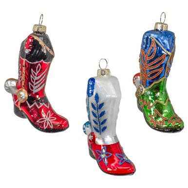 A blown glass cowboy boot ornament with painted tooling and a silver spur at the heel.
