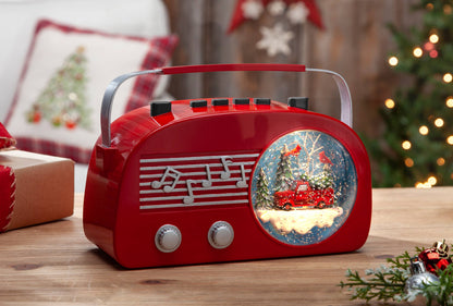 Gerson This retro snow globe features a vintage style red radio