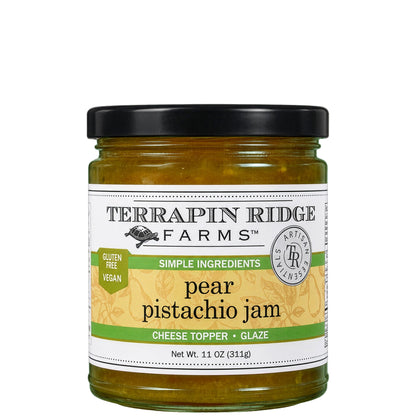A glass jar of Terrapin Ridge Farms pear pistachio jam with a black lid and a green and cream label reading net wt. 11 oz, gluten free and vegan.