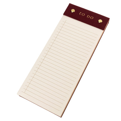 Burgundy Fabric-Bound Desktop Notepad, A burgundy fabric desktop notepad with to Do lettered in gold foil and two gold posts at the top.