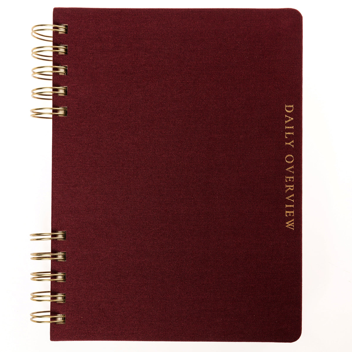 Burgundy Fabric-Bound Task Journal, A burgundy fabric-covered task journal with gold twin wire spirals and two maroon ribbon bookmark tabs, closed with an elastic band.