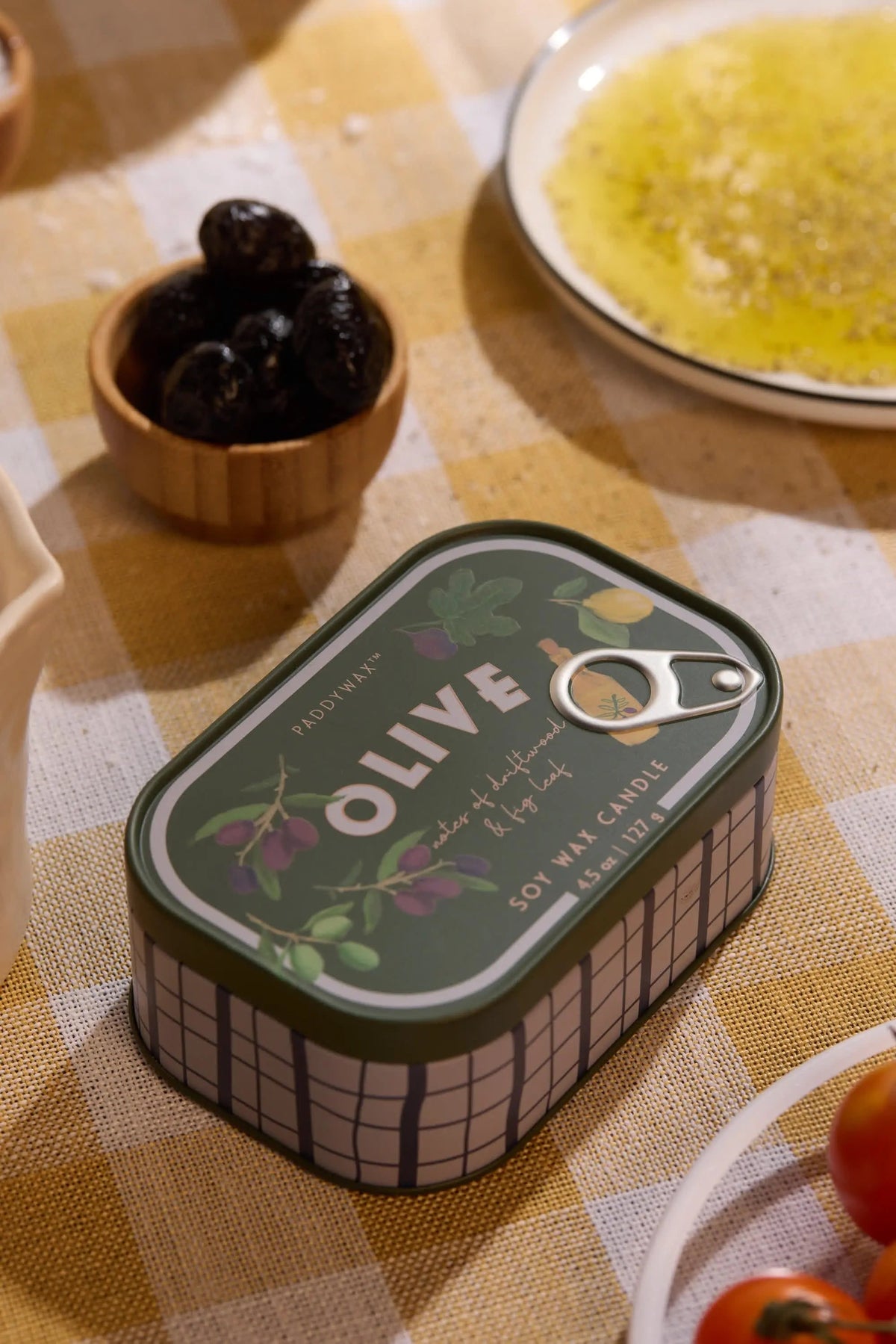 Bistro 4.5 oz Tin Candle, A pink tin candle illustrated with martini glasses, olives and a lemon, labeled Martini Soy Wax Candle.
