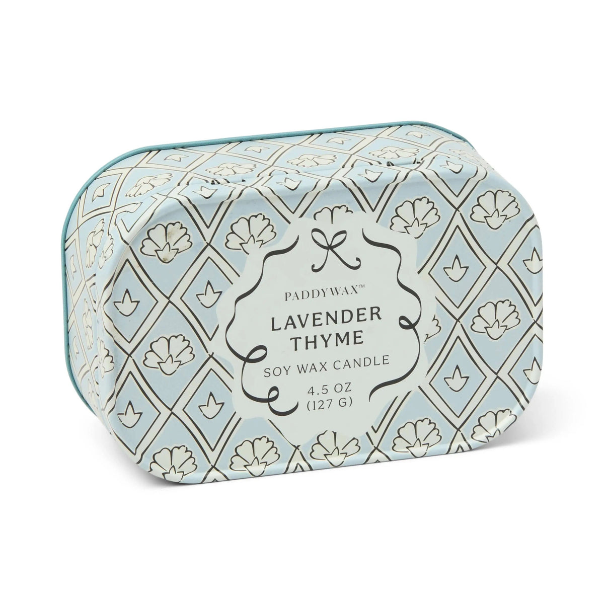 Chérie 4.5 oz Tin Candle, A black metal tin printed with a cream floral pattern, labeled Black Fig and Olive Soy Wax Candle.