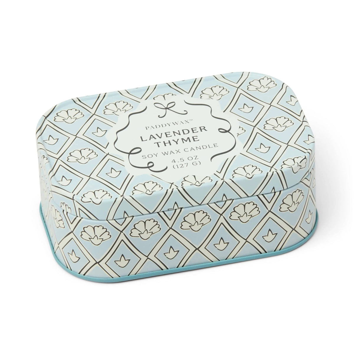 Chérie 4.5 oz Tin Candle, A black metal tin printed with a cream floral pattern, labeled Black Fig and Olive Soy Wax Candle.
