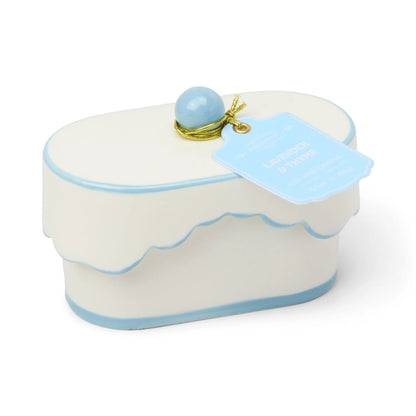 Chérie 5.5 oz Ceramic Candle, A white ceramic lidded candle box with a black scalloped rim and a round knob, tagged Black Fig and Olive.