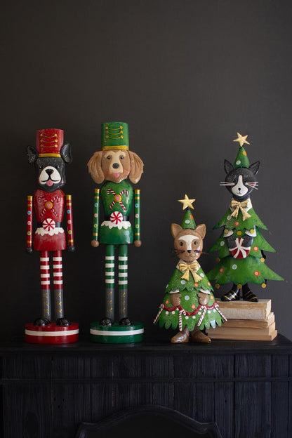 Painted Metal Dog Nutcracker, both designs styled on a dark console beside other Christmas pieces.