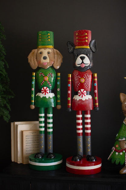 Painted Metal Dog Nutcracker, the two designs side by side at full height showing the peppermint belts and striped legs.