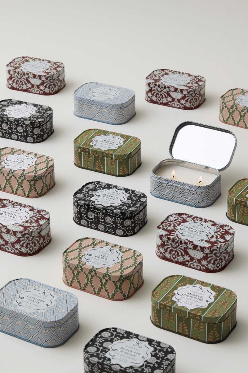 Chérie 4.5 oz Tin Candle, A black metal tin printed with a cream floral pattern, labeled Black Fig and Olive Soy Wax Candle.