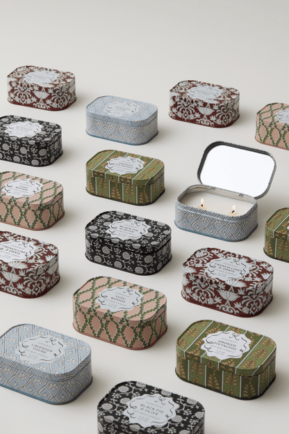 Chérie 4.5 oz Tin Candle, A black metal tin printed with a cream floral pattern, labeled Black Fig and Olive Soy Wax Candle.