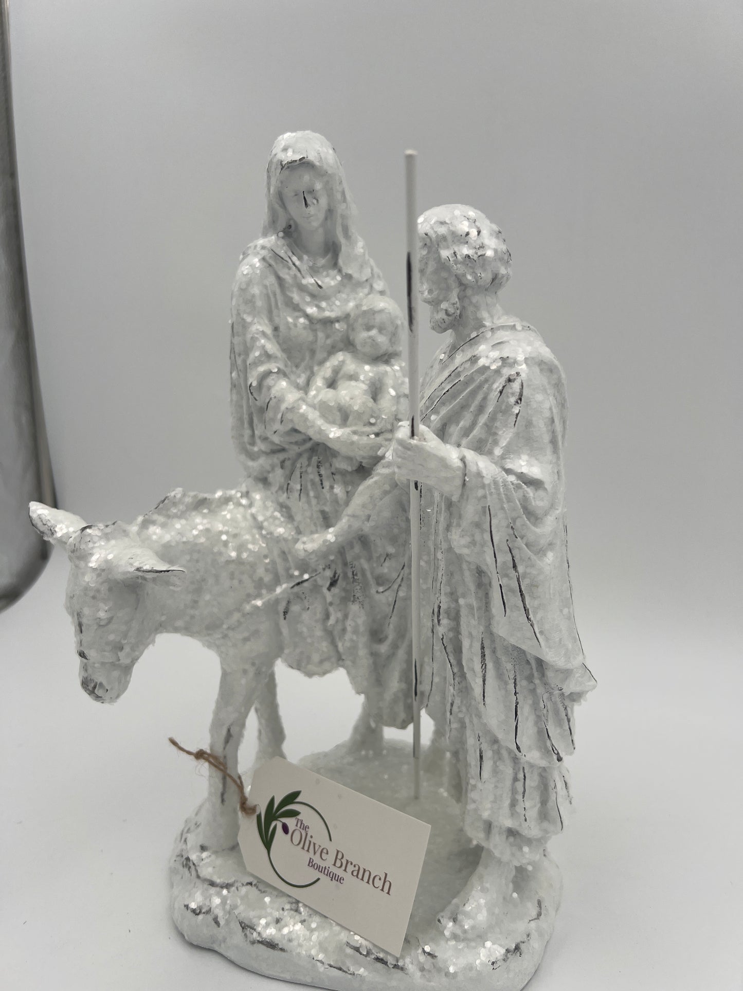 Natividad de José y María montados en burro con brillantina blanca